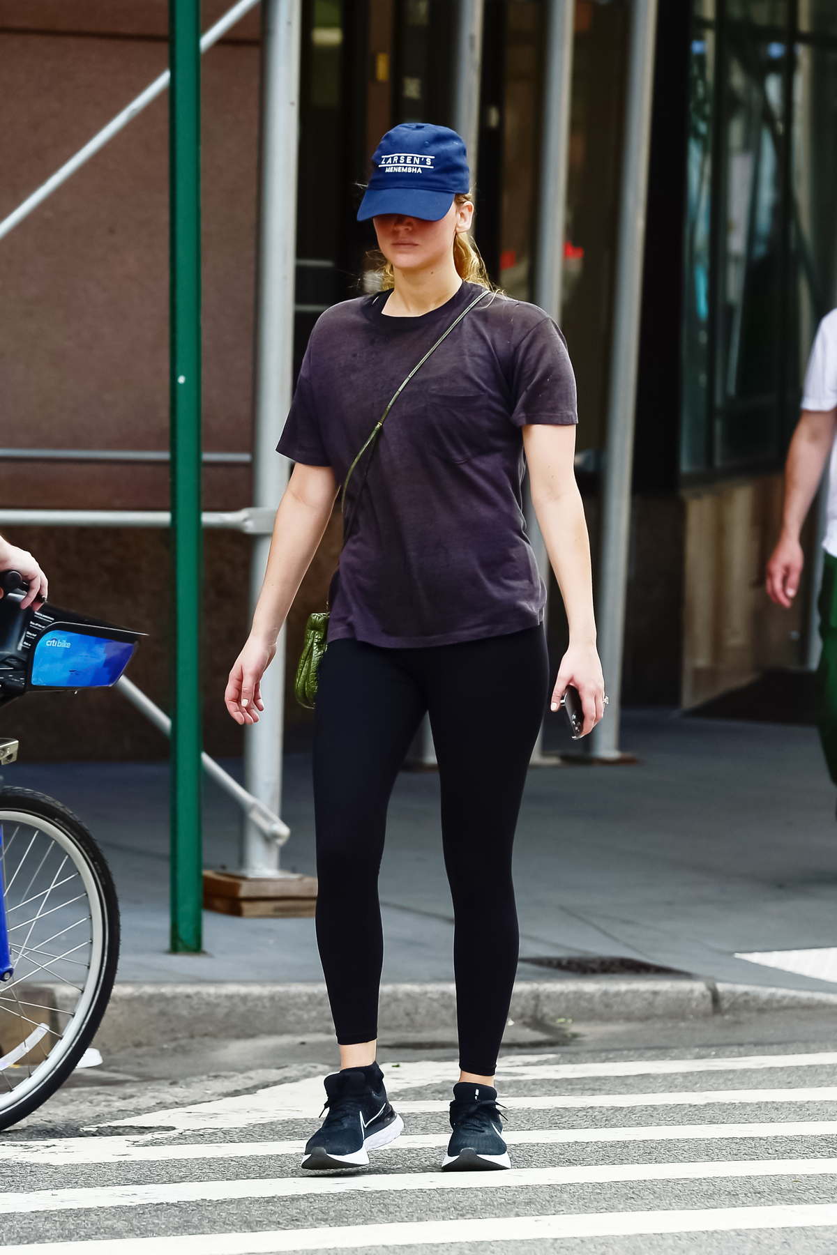 Jennifer Lawrence wears a black t-shirt with matching leggings while  heading to the Gym in