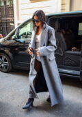 Kylie Jenner looks stylish in a white body suit and stockings with a grey trench coat as she arrives at her hotel in Paris, France