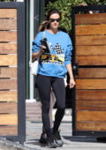 Alessandra Ambrosio looks fabulous in a blue sweater and black