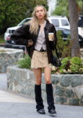 Alexis Ren rocks a leather jacket paired with a vest, mini skirt and leg warmers during a coffee run in Los Angeles
