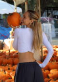Alexis Ren shows off her tiny waist in a white full-sleeve crop top and  track