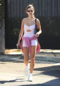 Eiza Gonzalez flashes her toned midriff in a white crop top and tight jeans  while making
