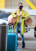 Kate Beckinsale looks striking in a neon yellow coat as she makes her way through the LAX in Los Angeles