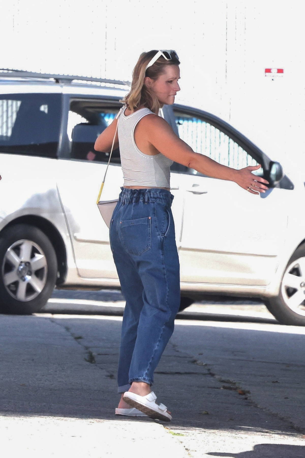 kristen bell wears a grey crop top and jeans while out to grab
