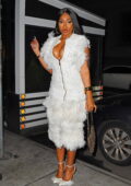 Megan Thee Stallion dons a plunging white feather dress as she attends the SNL after-party in New York City