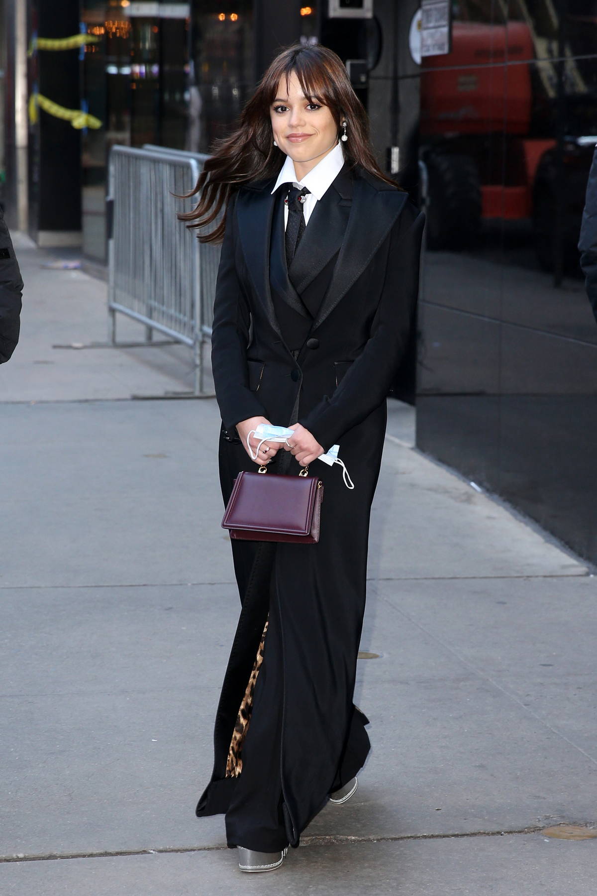Jenna Ortega keeps it stylish in a full-length black coat while visiting  'Good Morning America