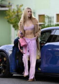 Joy Corrigan flaunts her incredible abs in a pink bra top while stepping out in her new Porsche Taycan in Los Angeles