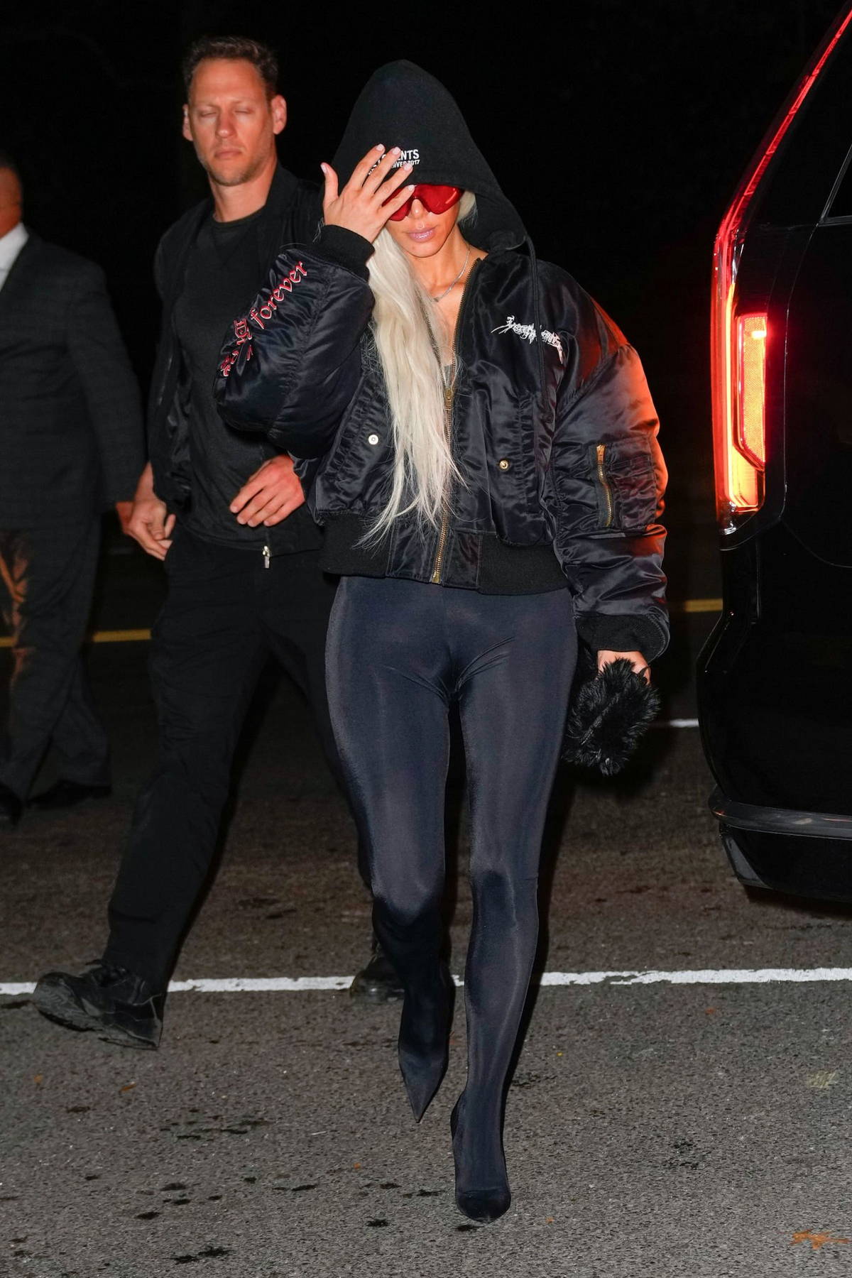kim kardashian keeps a low profile in a black hoodie, puffer jacket and ...