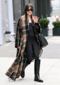 Lea Michele wears a plaid winter coat while heading out in New York City