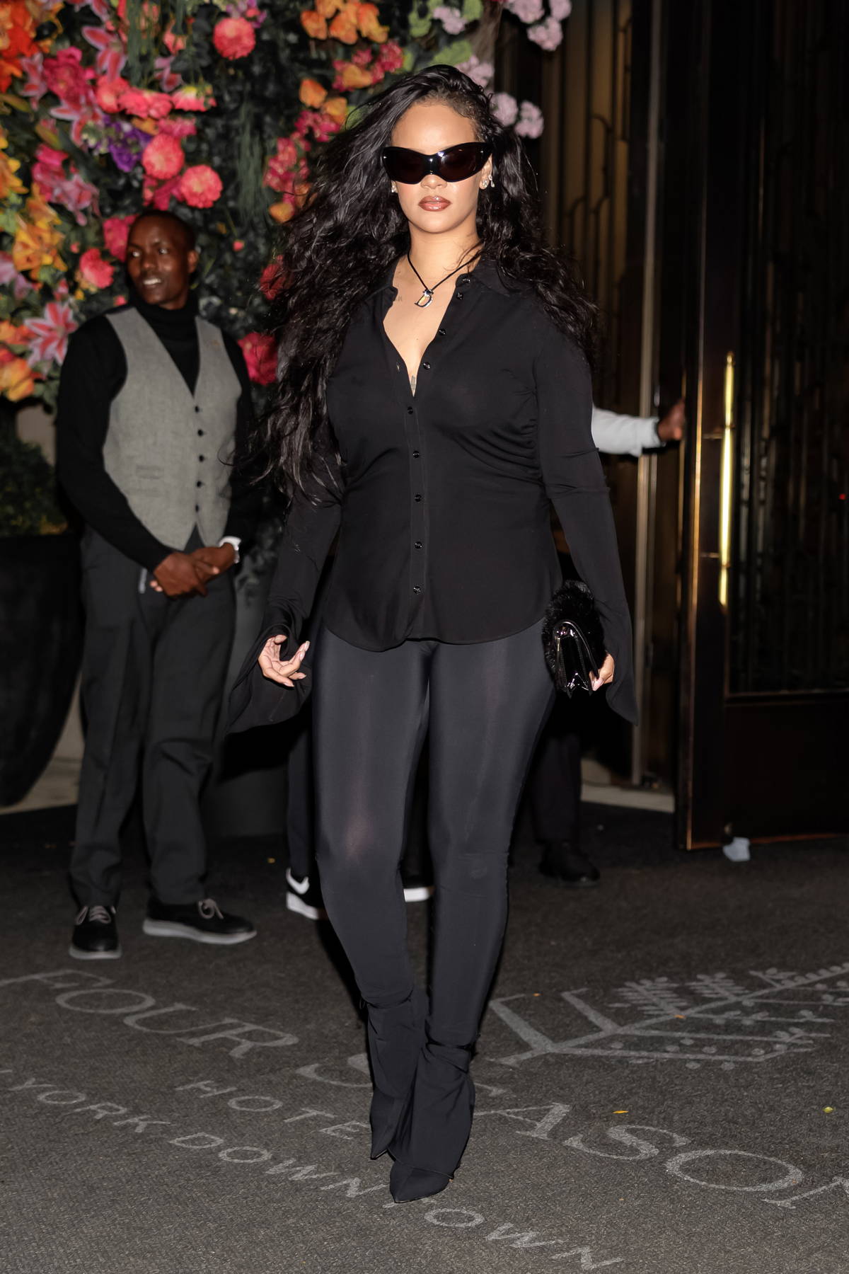 Rihanna looks stunning a black shirt with matching leggings and heels while  stepping out for dinner