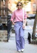 Sienna Miller looks pleasant in a pink sweater and lavender pants while out running errands in New York City