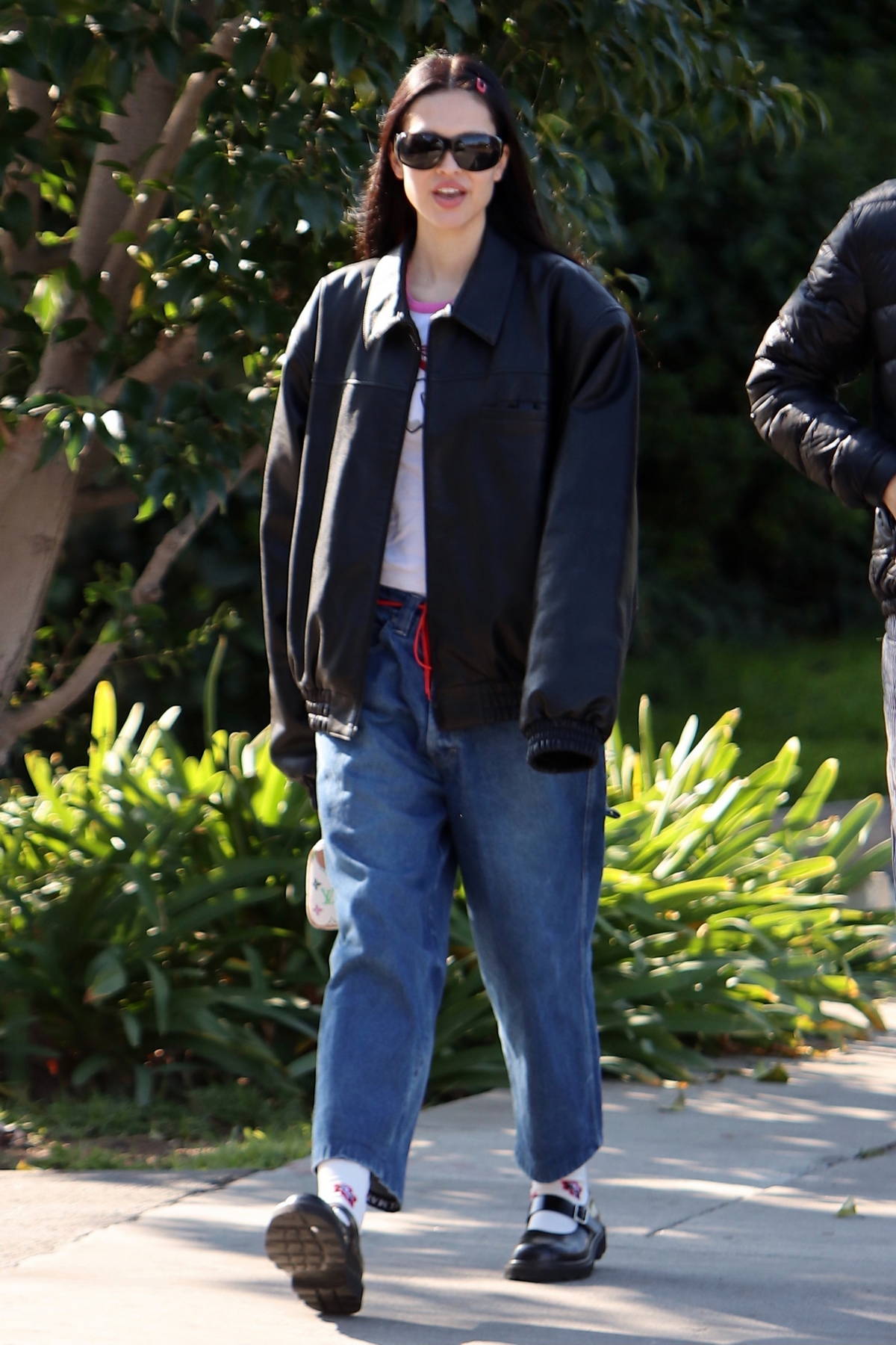 Kendall Jenner wears a knitted blue cardigan with a white top and