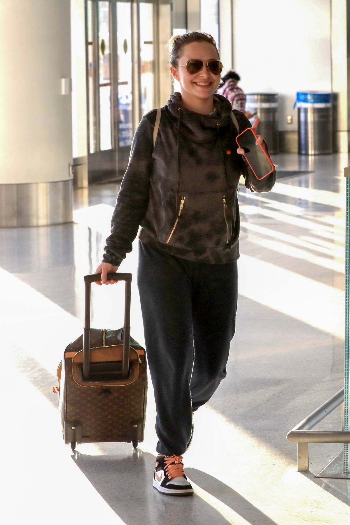 Hilary Duff arrives at the airport carrying Louis Vuitton luggage