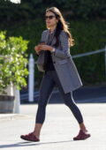 Jordana Brewster wears a striped coat and leggings while stopping by the Brentwood Country Mart in Brentwood, California