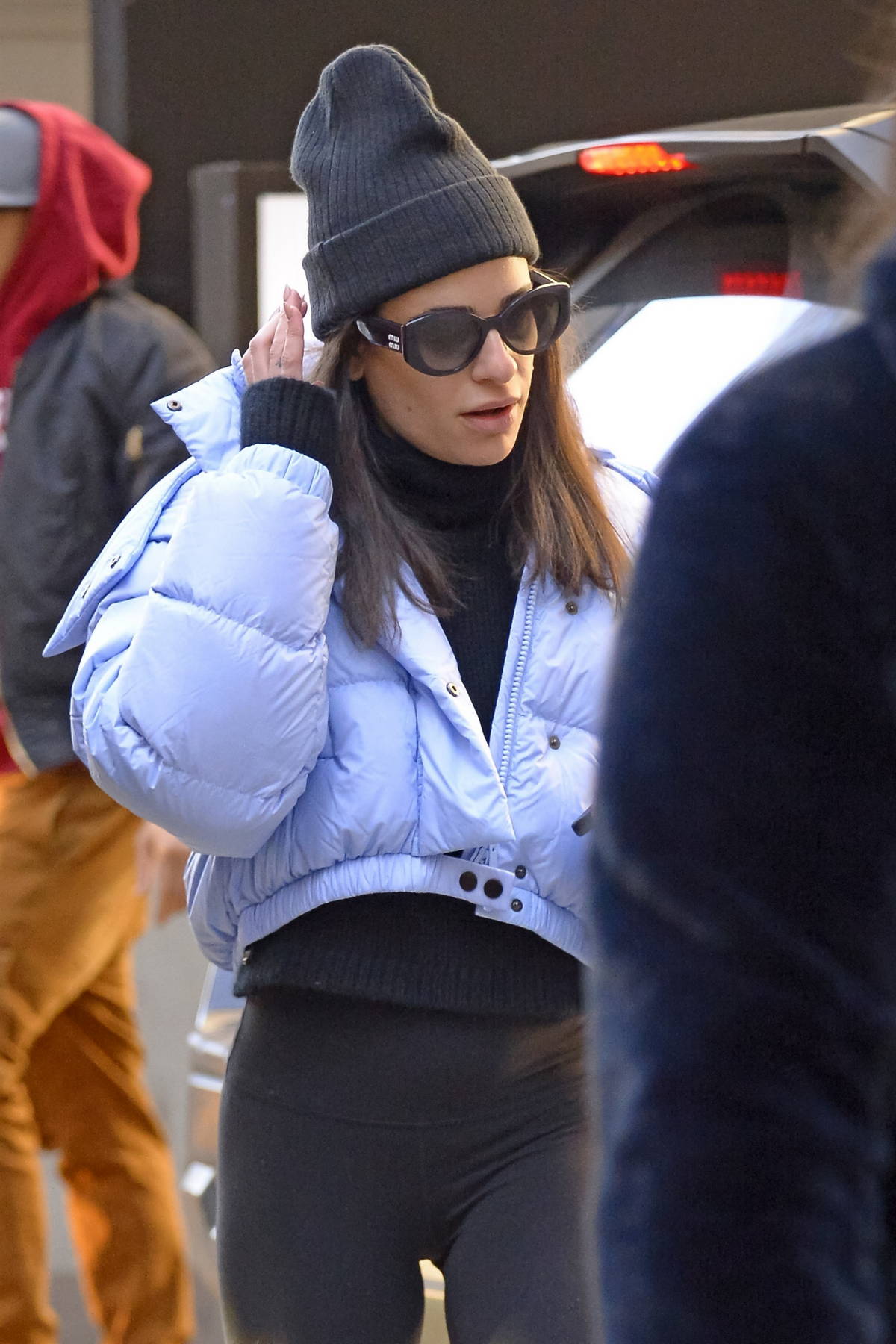 Lea Michele stays warm in a puffer jacket and leggings while arriving on ' Funny Girl' on