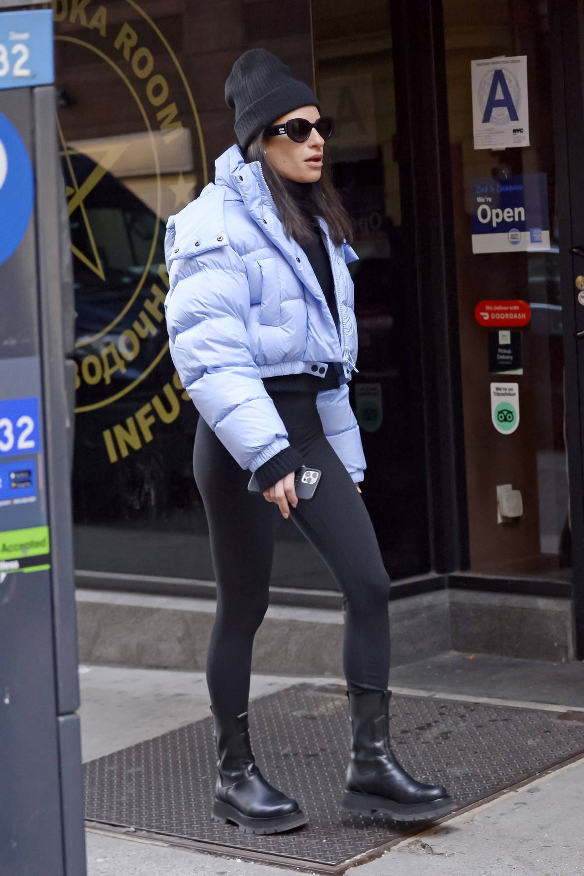 Lea Michele stays warm in a puffer jacket and leggings while arriving on ' Funny Girl' on