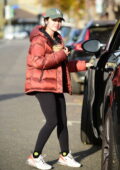 Lucy Hale wears a red 'LA' hat with denim jacket and black leggings during  a coffee