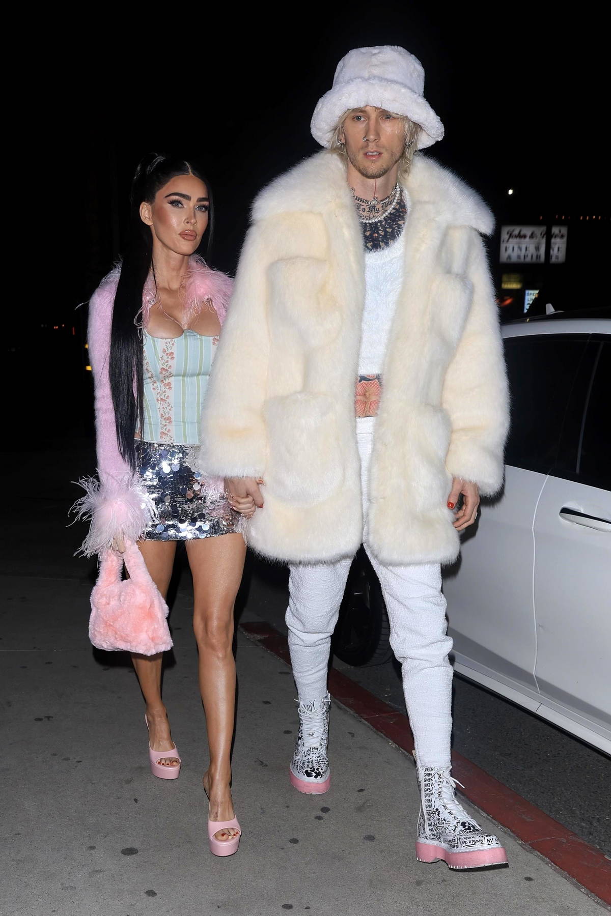 Megan Fox looks stunning in a pink fur coat with matching handbag and ...