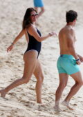 Rhea Durham wears a black swimsuit as she goes for a swim with husband Mark Wahlberg in Bridgetown, Barbados