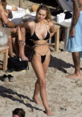 Alexis Ren shows off her incredible beach body in a black bikini while enjoying the sun and the sea in St Barts, France