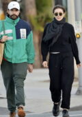 Elizabeth Olsen keeps cozy in all-black sweats while out to grab some food to-go with husband Robbie Arnett in Los Angeles