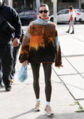 Hailey Bieber looks trendy in a colorful sweater and brown leggings while  out for brunch with