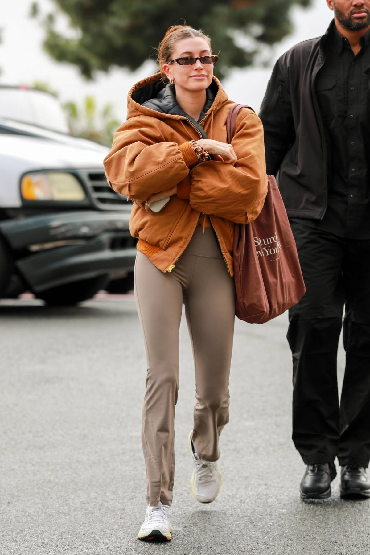 Hailey Bieber rocks a tan jacket and flared leggings for a hot yoga session  in West