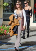 Hailey Bieber rocks a tan jacket and flared leggings for a hot