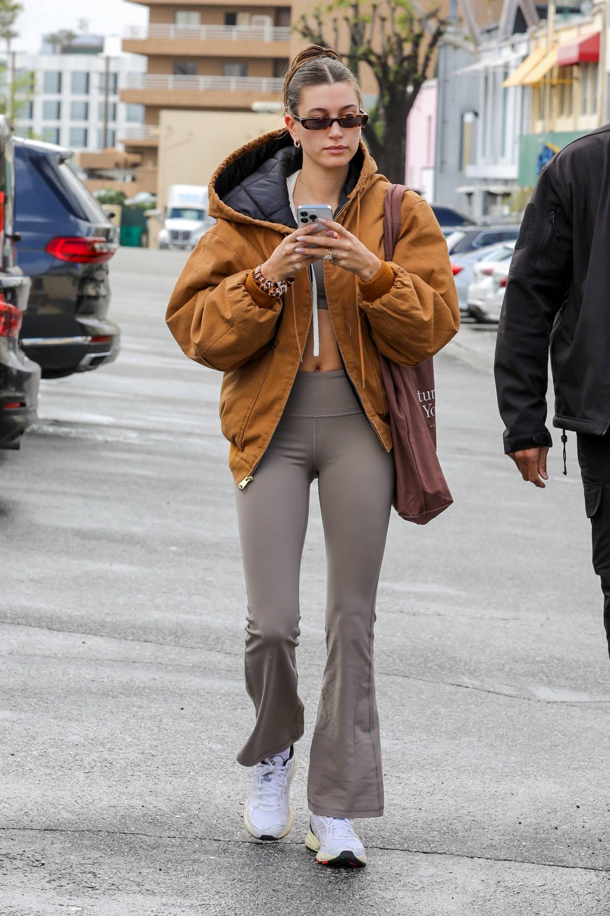 Hailey Bieber rocks a tan jacket and flared leggings for a hot