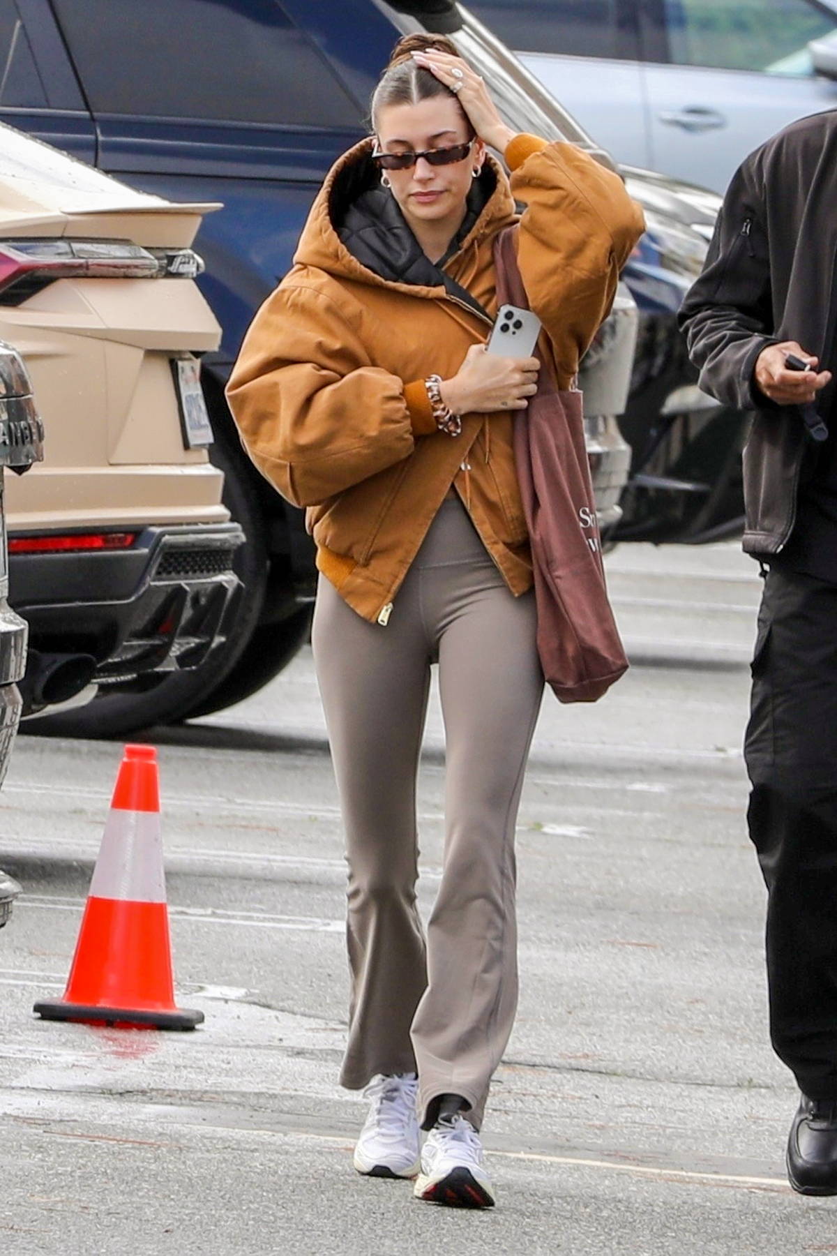 hailey bieber rocks a tan jacket and flared leggings for a hot