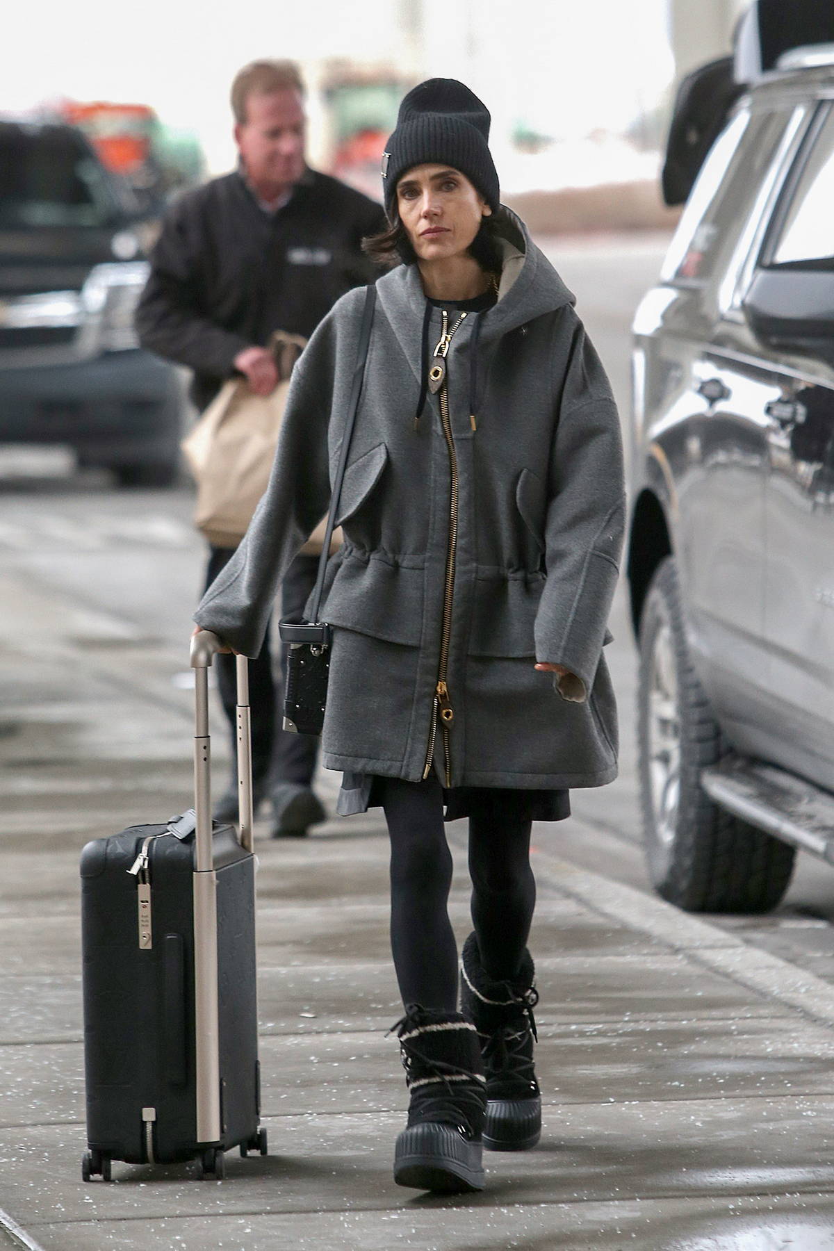 jennifer connelly dons a grey jacket, black tights and louis vuitton moon  boots as she arrives at the airport in salt lake city, utah-230123_3