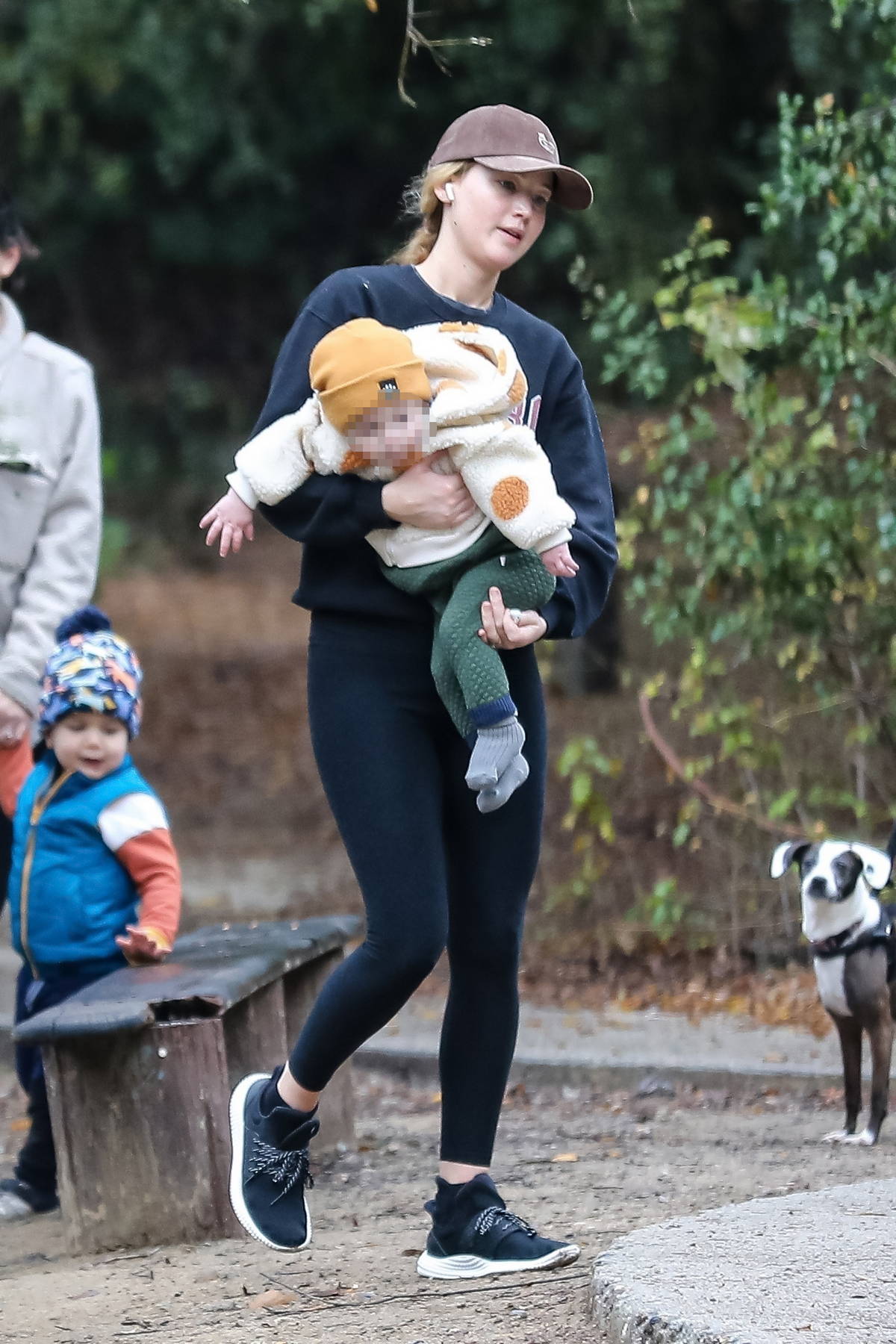 Jennifer Lawrence keeps warm in a sweater top and leggings as she takes her  baby boy