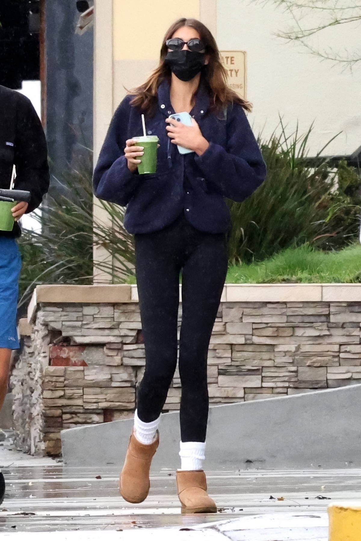 Kaia Gerber wears a navy fleece and black leggings while out for a