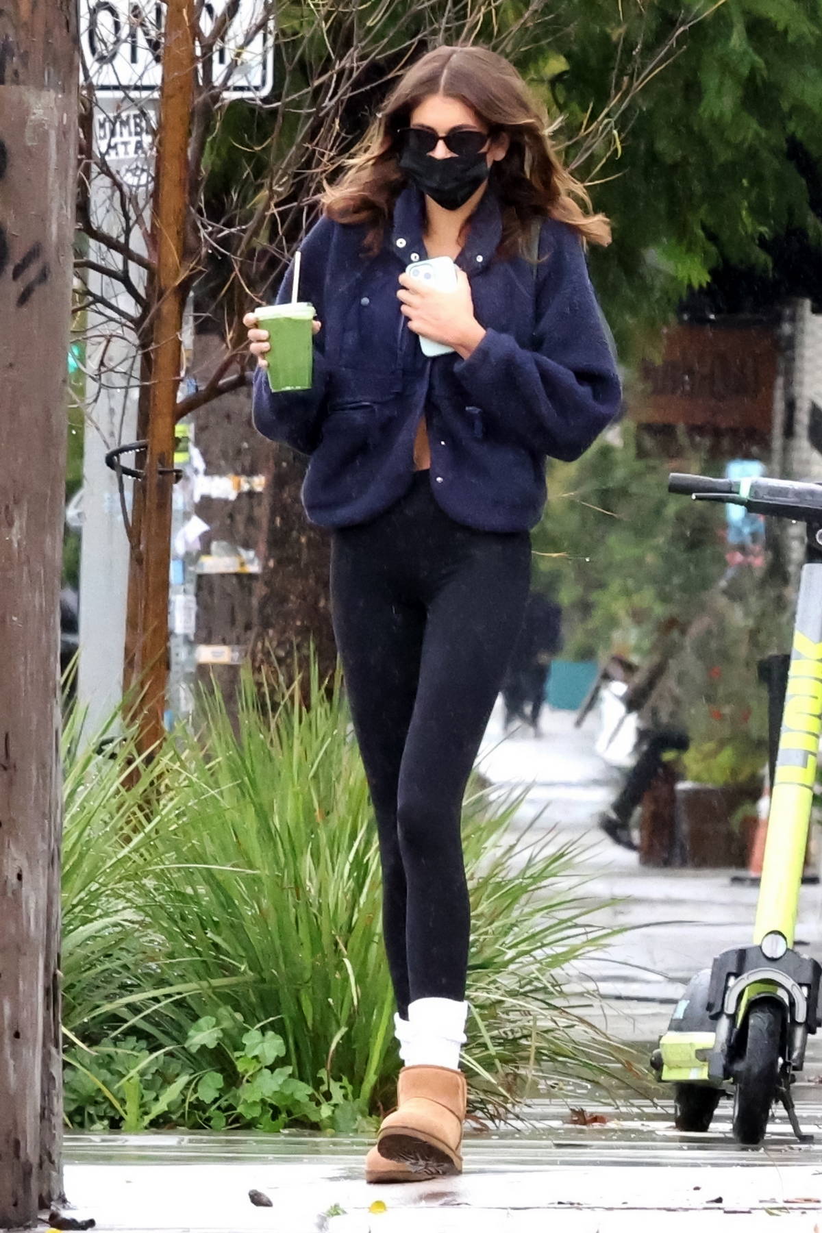 kaia gerber wears a navy fleece and black leggings while out for a green  juice with bff travis jackson in los feliz, california-100123_7