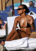 Karrueche Tran catches some sun in a black bikini during a beach day in Miami Beach, Florida