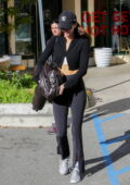 Kendall Jenner dons a leather jacket and flared leggings for a hot