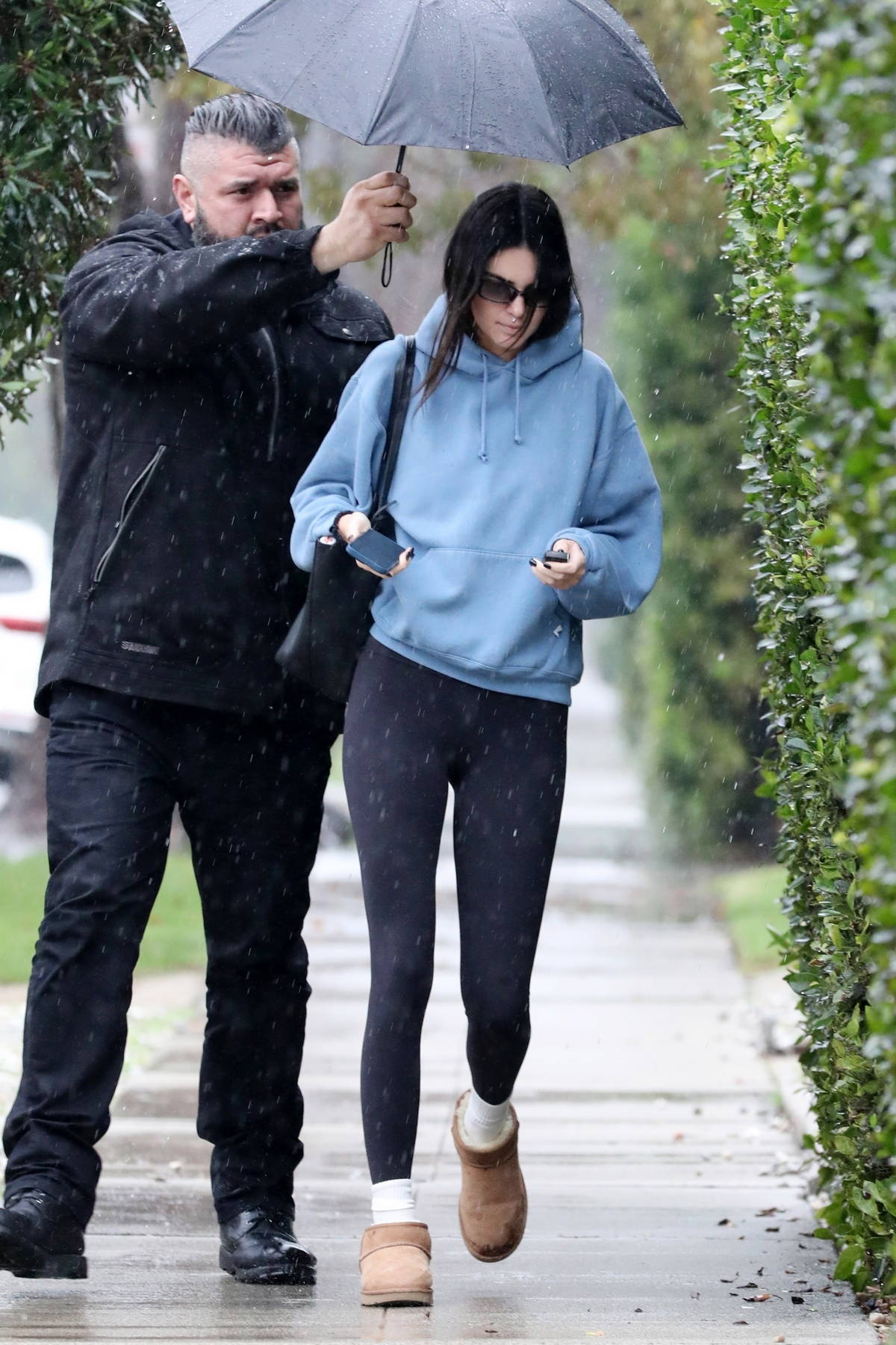 https://www.celebsfirst.com/wp-content/uploads/2023/01/kendall-jenner-sports-a-hoodie-and-leggings-as-she-braves-the-rain-while-running-a-few-errands-in-beverly-hills-california-140123_16.jpg
