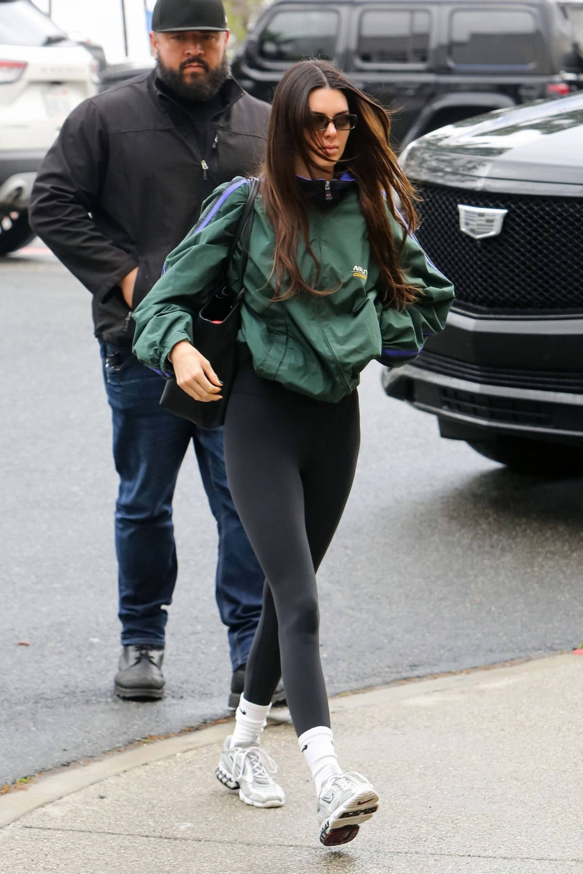 kendall jenner wears a green nautica jacket and black leggings