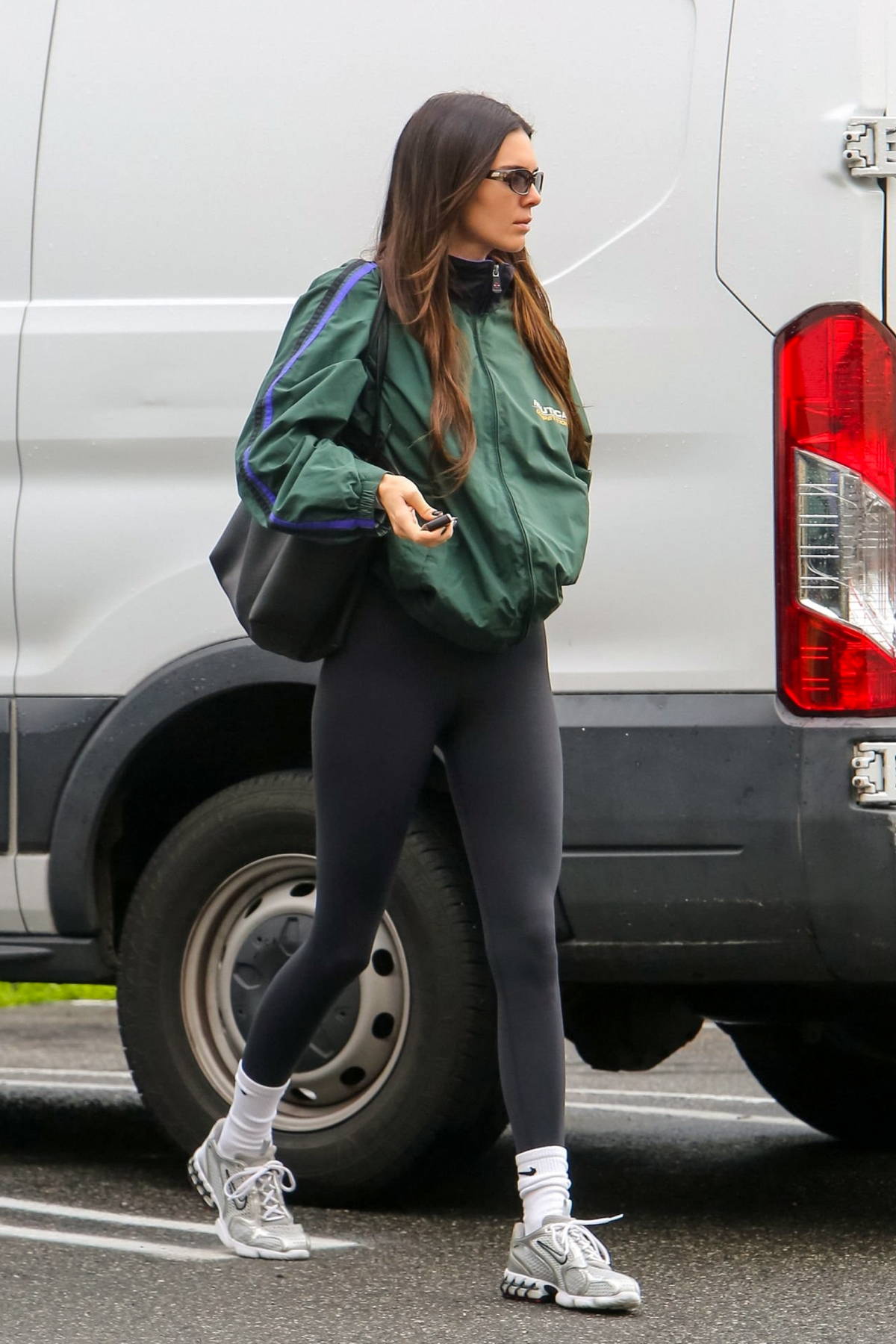 https://www.celebsfirst.com/wp-content/uploads/2023/01/kendall-jenner-wears-a-green-nautica-jacket-and-black-leggings-while-attending-a-hot-yoga-class-in-west-hollywood-california-050123_2.jpg
