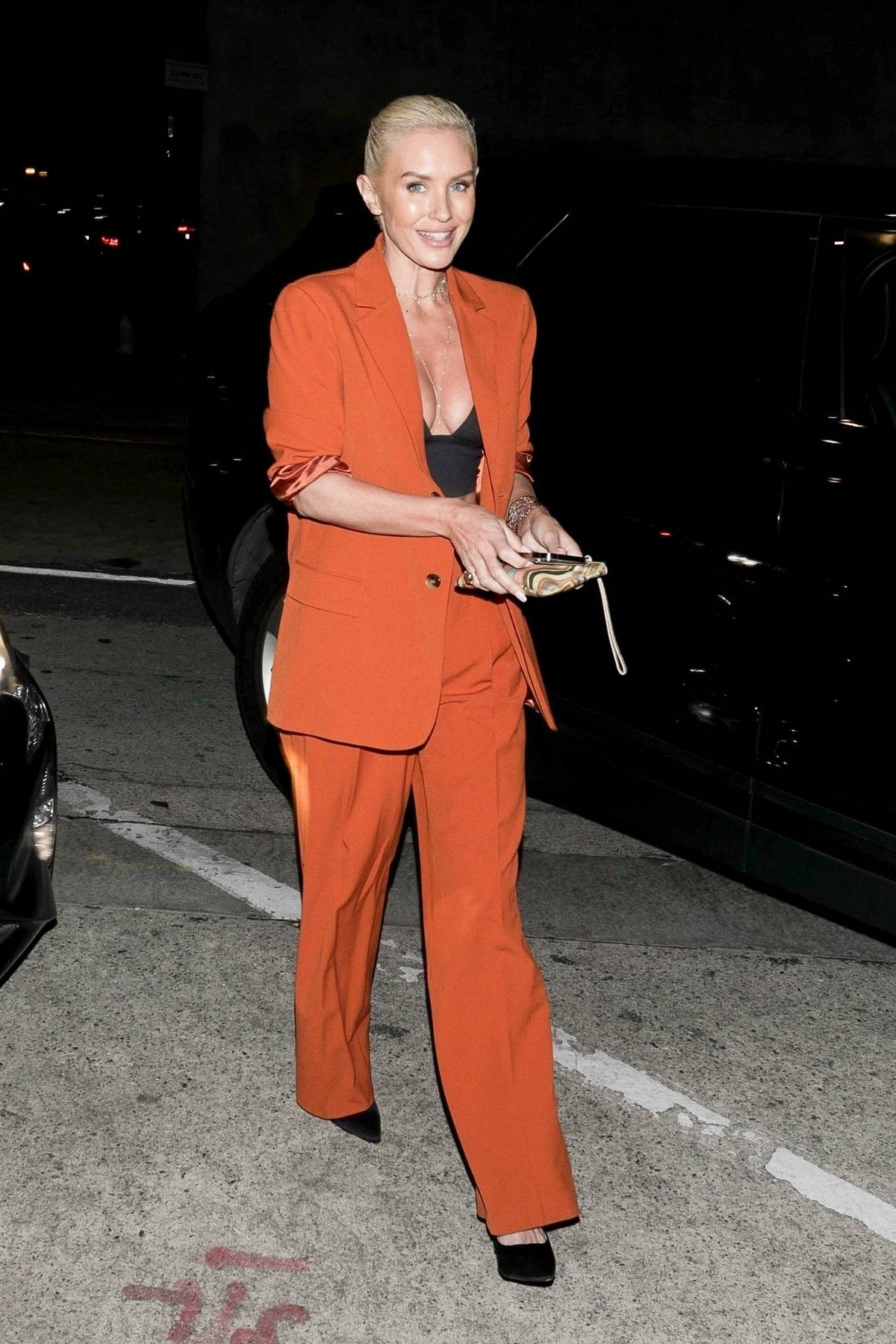 Nicky Whelan looks good in an orange pantsuit as she steps out for dinner  at Craig's in West Hollywood, California