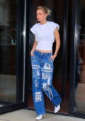 Gigi Hadid looks trendy in blue jeans and a white top paired with white heels while heading out in New York City