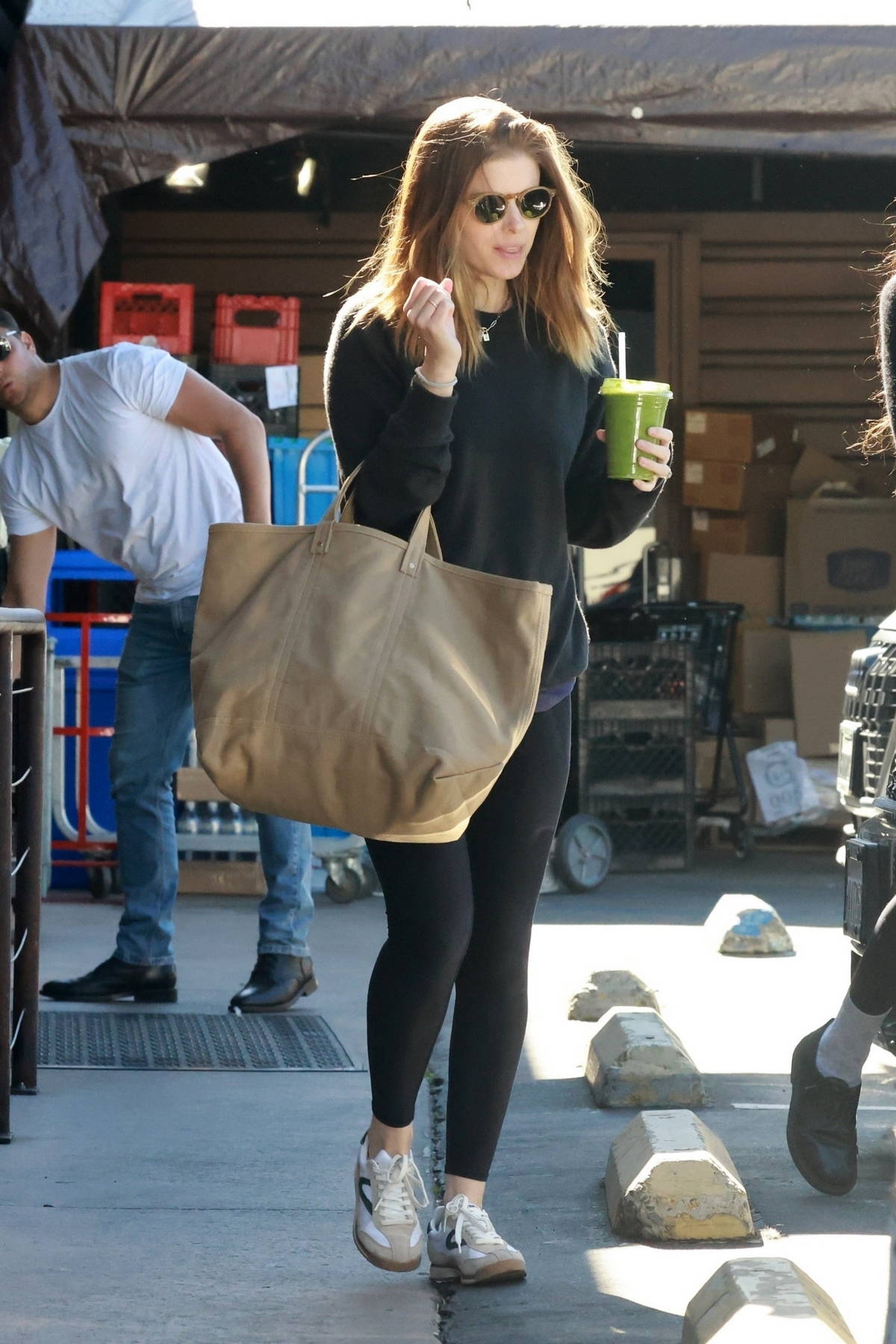 Addison Rae goes makeup free in an oversized t-shirt and leggings during  her morning coffee