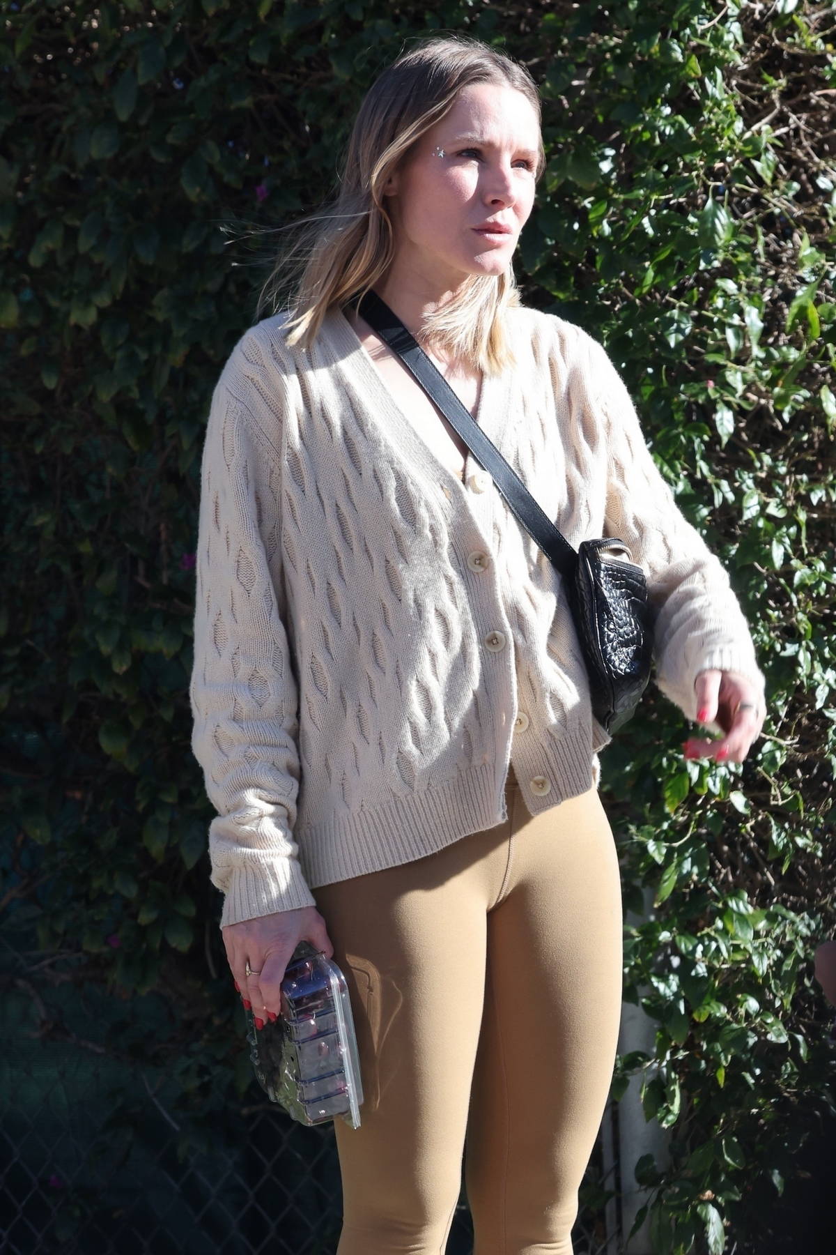 Kristen Bell wears a knitted cardigan and leggings as she leaves