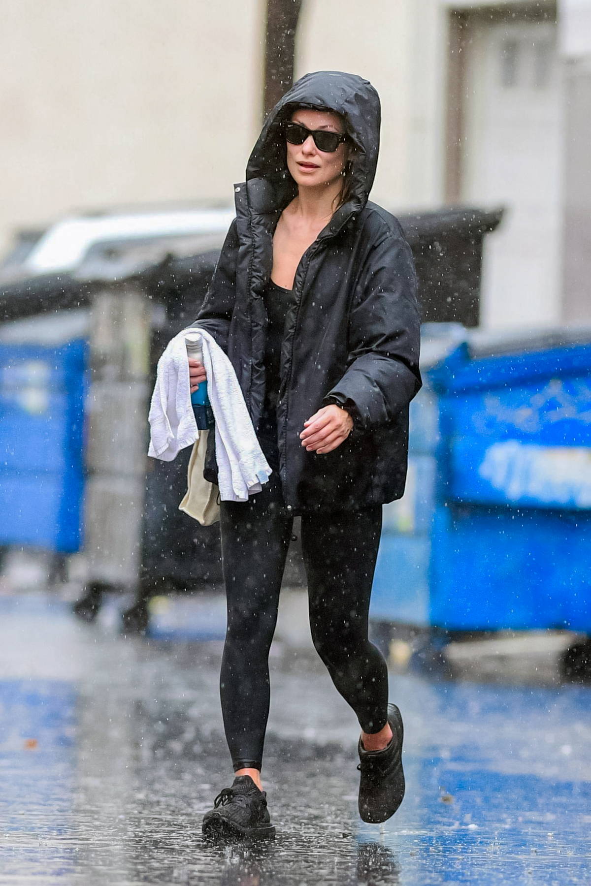 Olivia Wilde braves the rain in a hooded jacket and leggings while out for  her daily