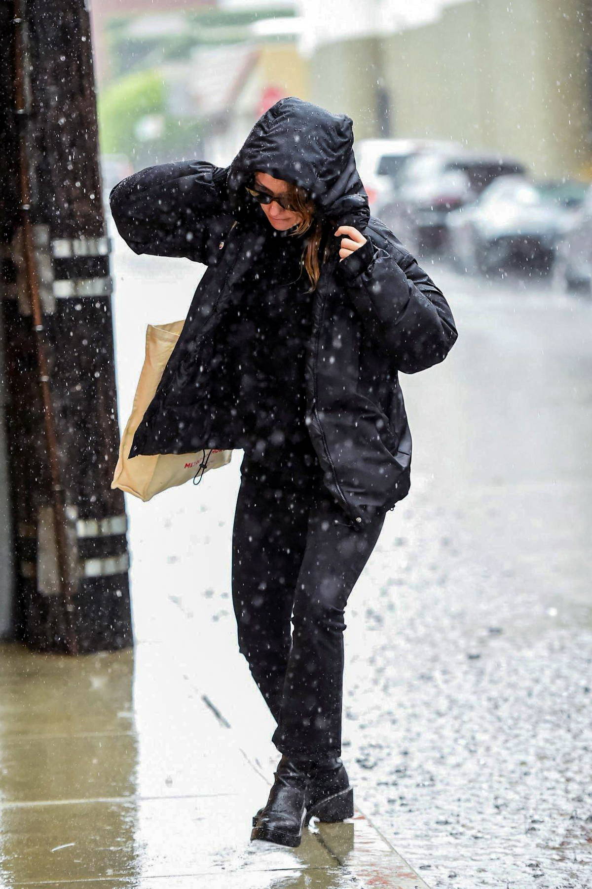 Olivia Wilde braves the rain in a hooded jacket and leggings while out for  her daily