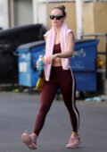 Olivia Wilde shows off her toned abs in a maroon sports bra and