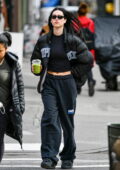 Amelia Hamlin flashes abs in a black crop top with a Supreme puffer jacket while out on a iced matcha run in New York City