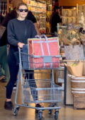Elizabeth Olsen wears a black sweatshirt and leggings for some grocery shopping at Erewhon Market in Studio City, California
