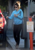 Katherine Schwarzenegger wears a blue hoodie and black leggings while she picks up coffee in Los Feliz, California