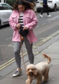 Kelly Brook wears a pink jacket and grey leggings while walking her dog around Soho in London, UK